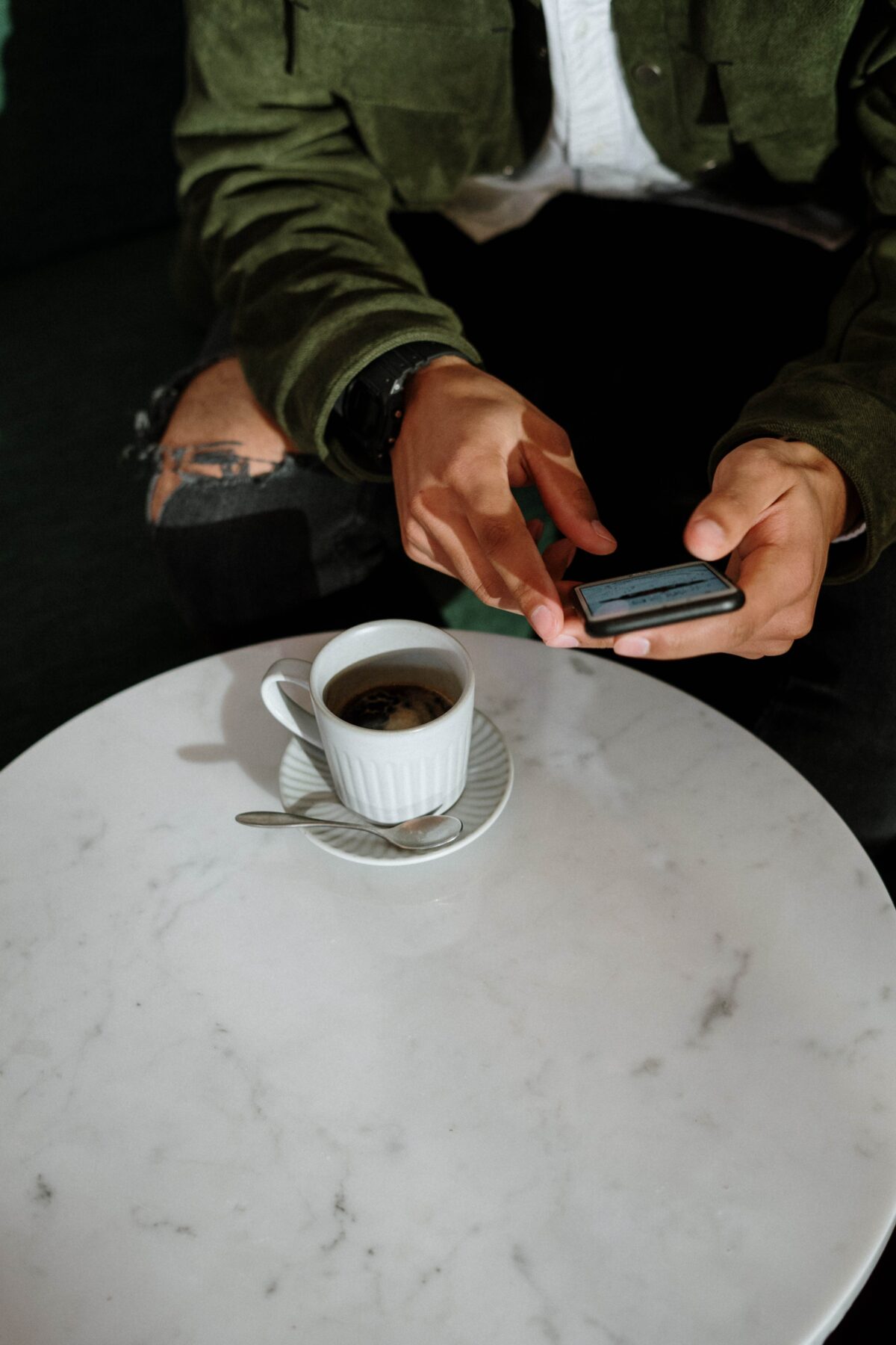 man enjoying coffee and looking at phone