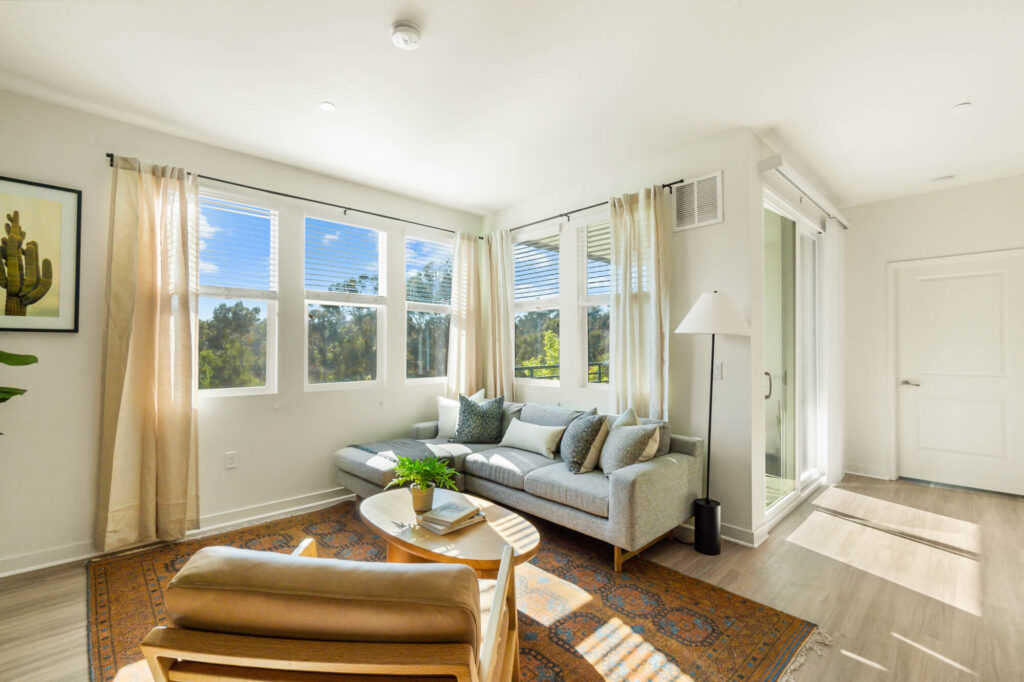 Living room with large windows at Ascent at Campus of Life San Diego apartments for rent