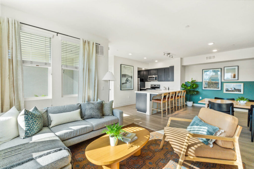Open concept kitchen, living and dining room at Ascent at Campus of Life pet-friendly apartments in San Diego