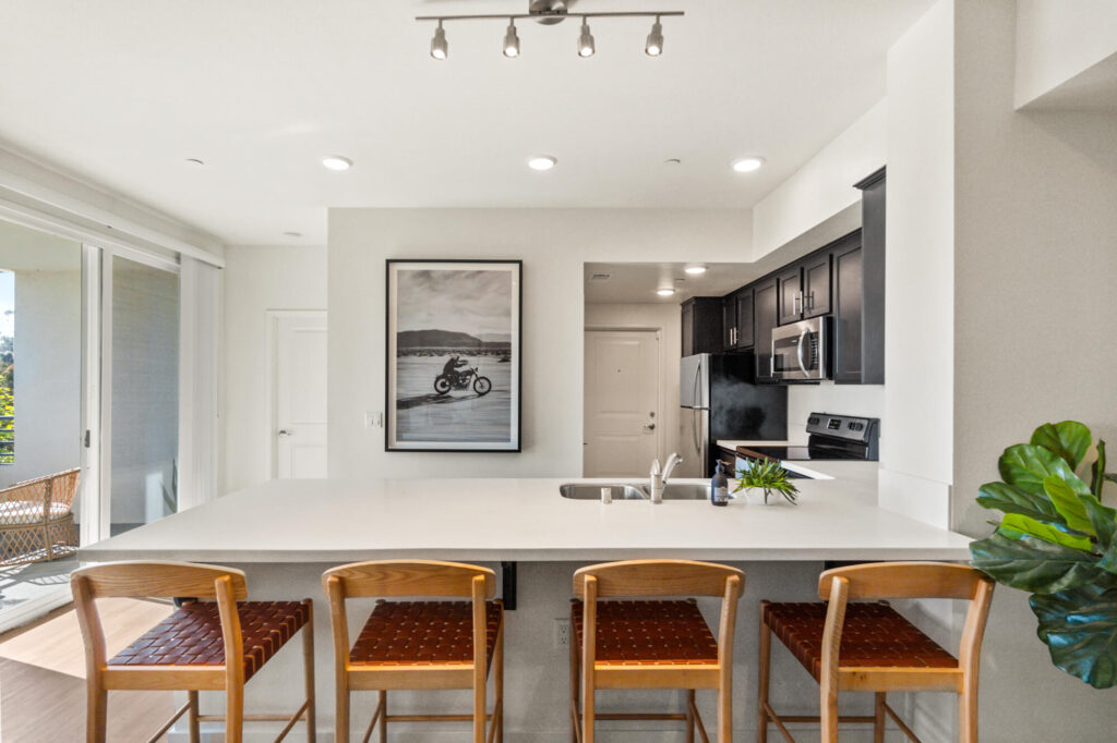 Kitchen with bar seating at Ascent at Campus of Life luxury apartments in San Diego