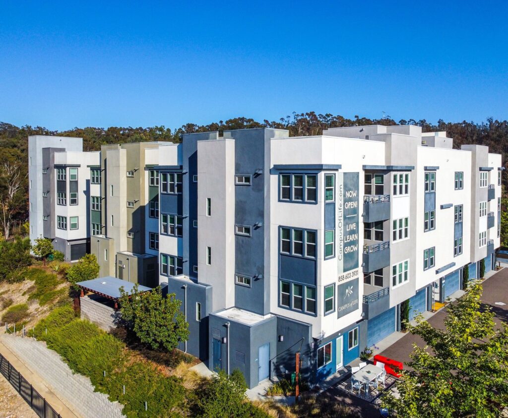Aerial view of building showing surrounding trees and outdoor seating