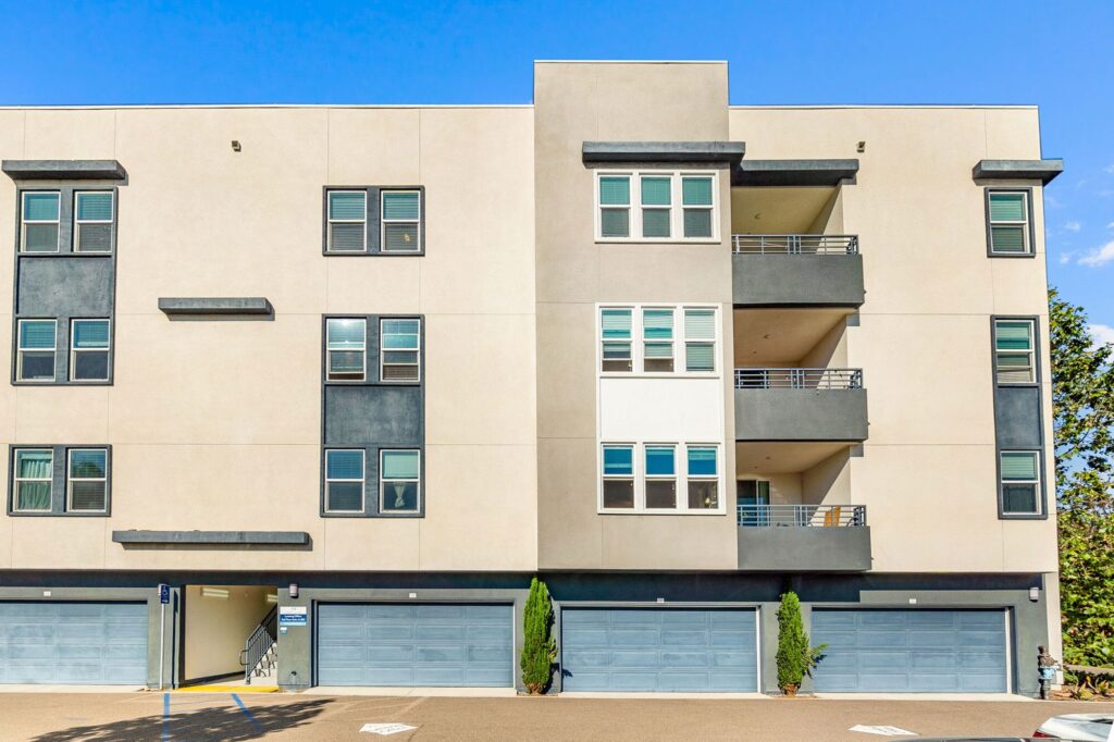 Building exterior with garages and balconies