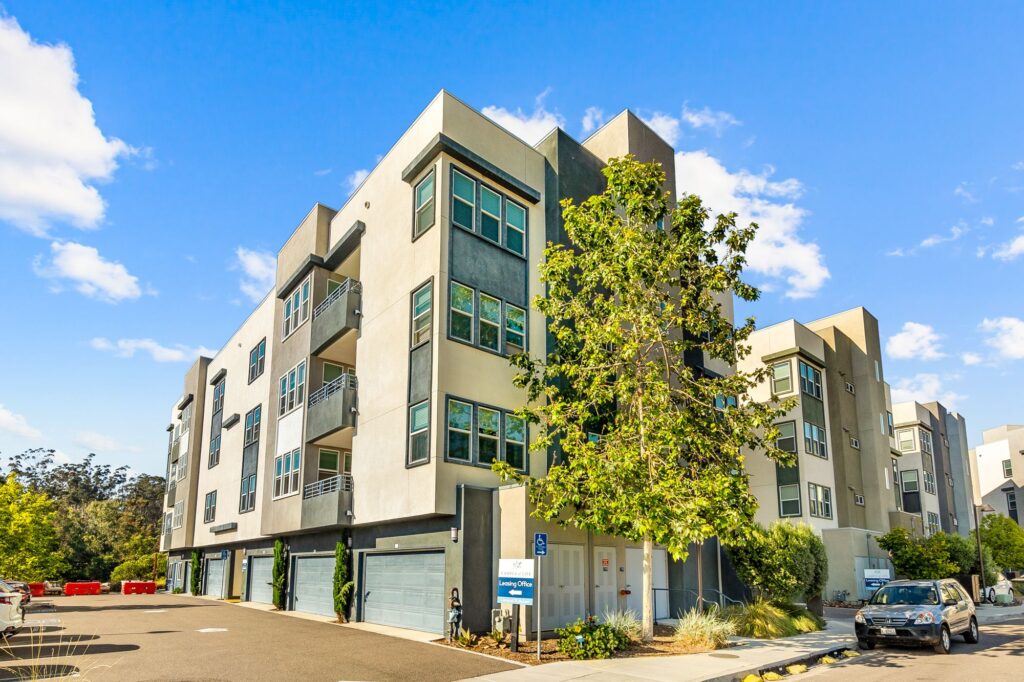 Building exterior with garages and balconies and trees