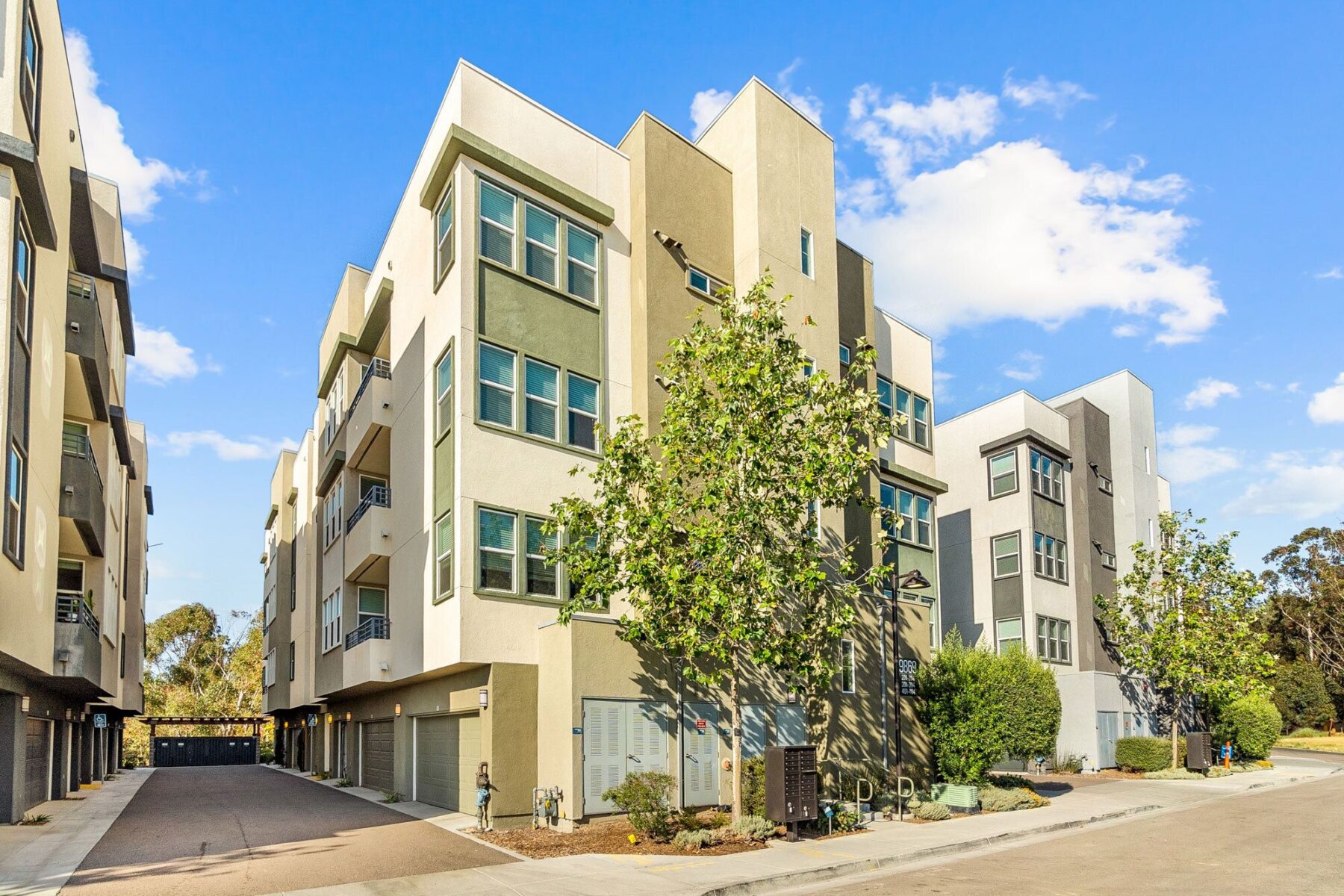 Building exterior with garages and balconies and mailboxes