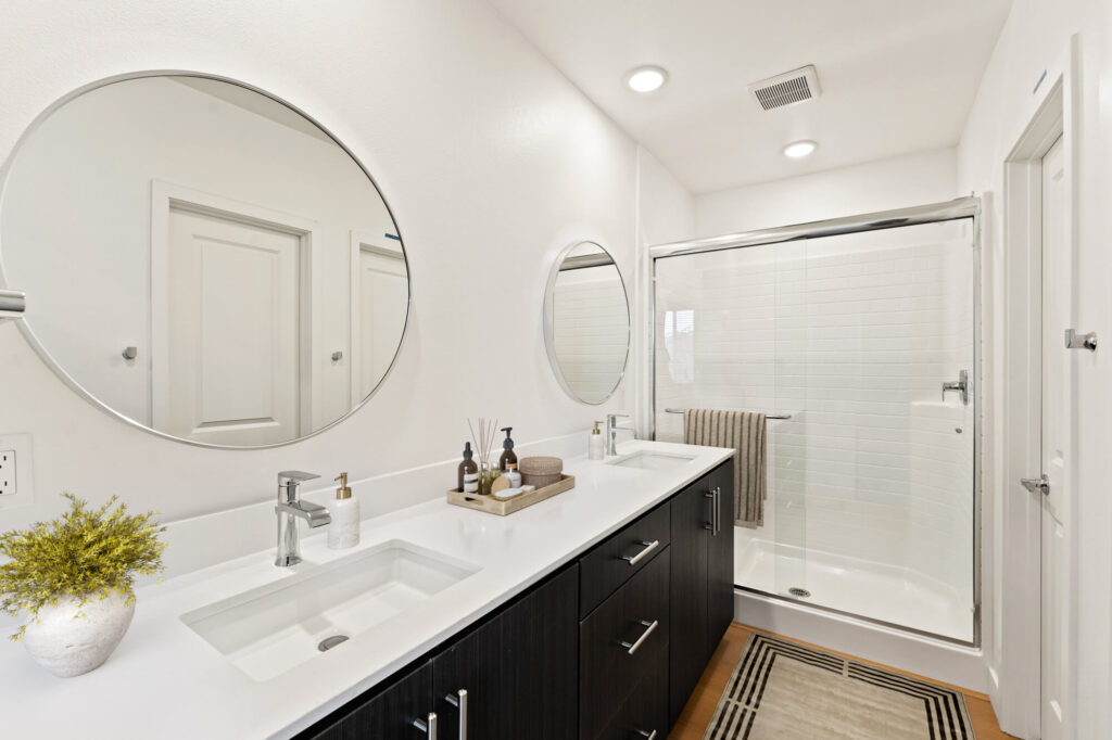 Bathroom with dual sink and walk in glass shower