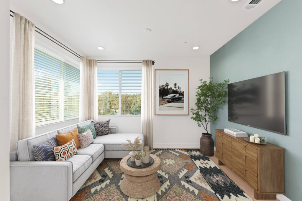 Living room with wood-style flooring, television, wall decor, windows, and couch seating