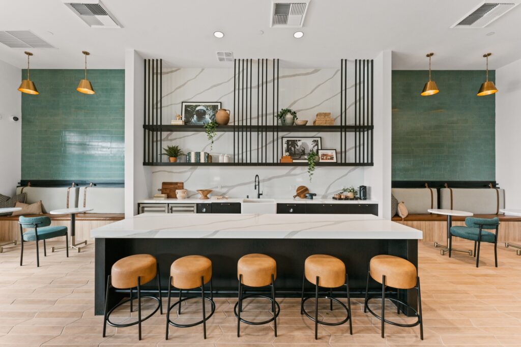 Kitchen with white counters, black cabinets, and stainless steel appliances