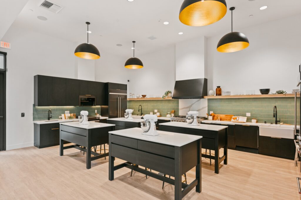 Kitchen with white counters, black cabinets, and stainless steel appliances